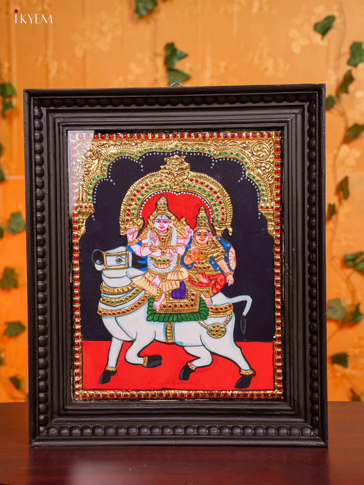 Tanjore Painting Of Siva Parvathi Seated On Nandhi in Teak Frame (18x15 Inch) - KH26190